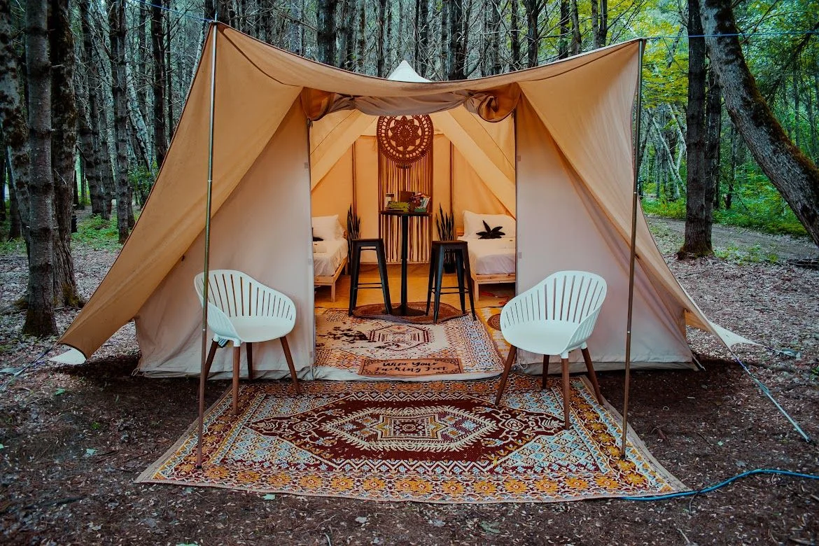 Furnished glamping tent among the trees