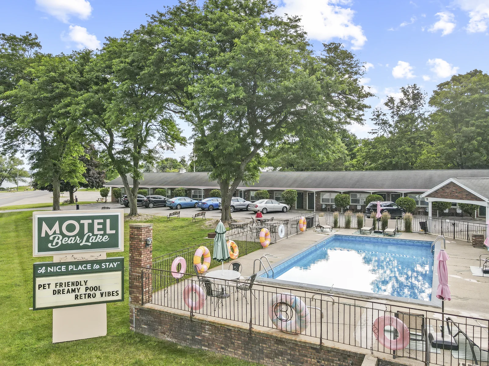 The motel, pool, and roadside sign